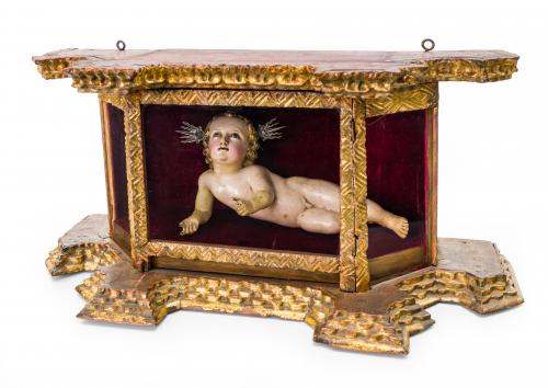 Niño Jesús recostado con urna de cristal con marco dorado